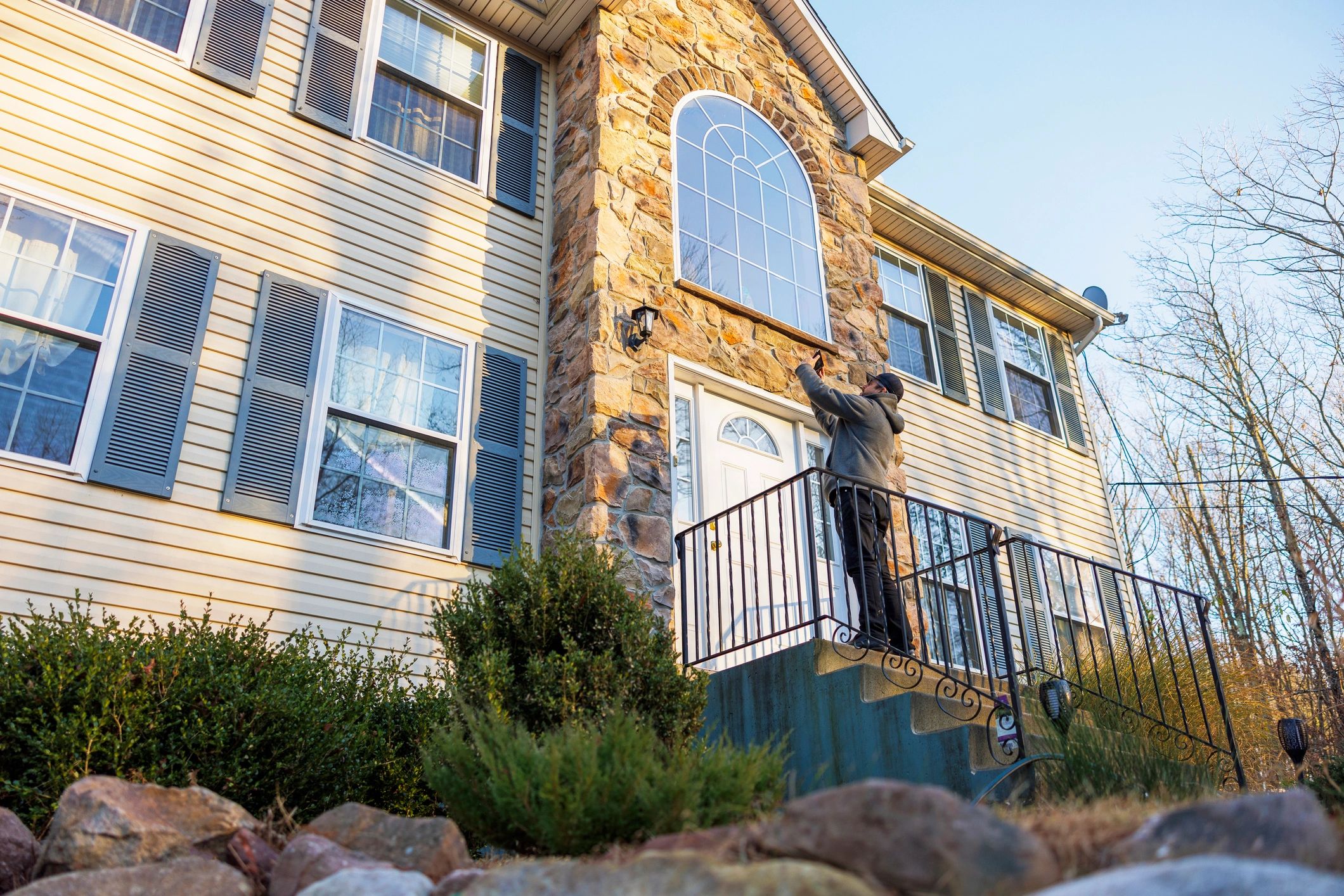 Person taking a photo of a home exterior