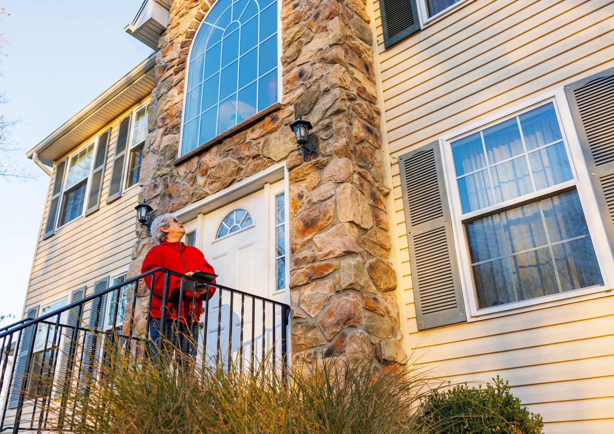 Homeowner standing on a front porch