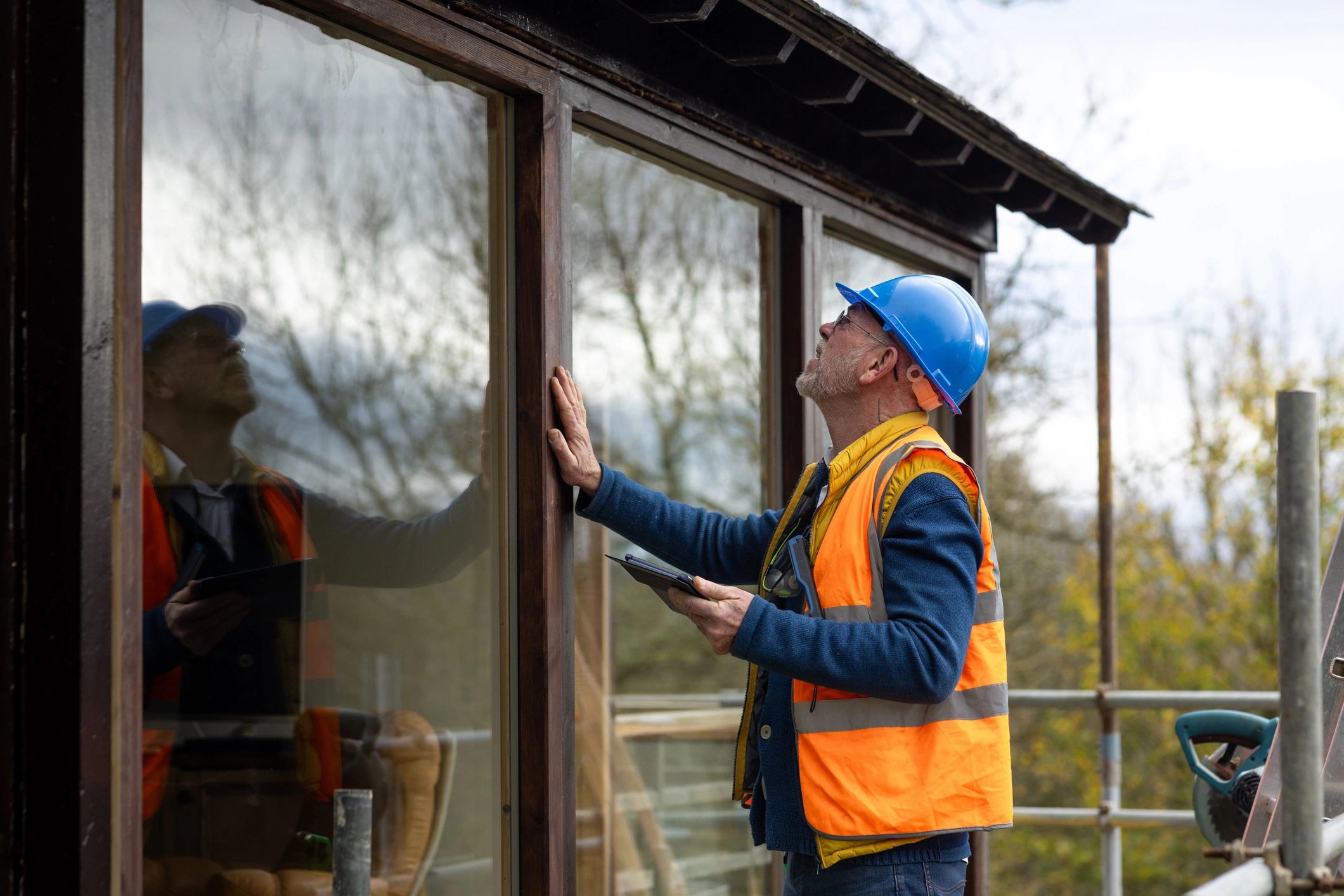 Home maintenance professional on an exterior inspection